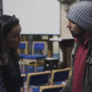Actor-led church safeguarding training scene produced for Church of England Birmingham, showing a discussion between two people inside a church setting.