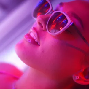 Beautiful young woman lying on a sunbed studio shot
