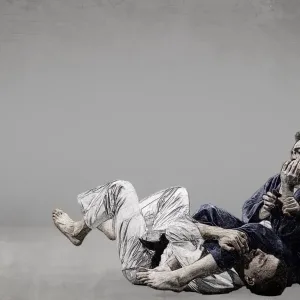 Two judo athletes grapple on the mat in an illustrated style with a grey textured background