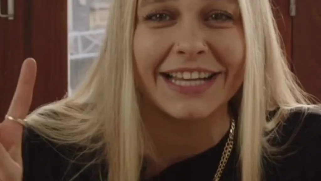 A portrait of musician Kimmy Beatbox smiling and giving a peace sign, filmed during a social content production shoot for Creative UK and the Creative Coalition Festival.