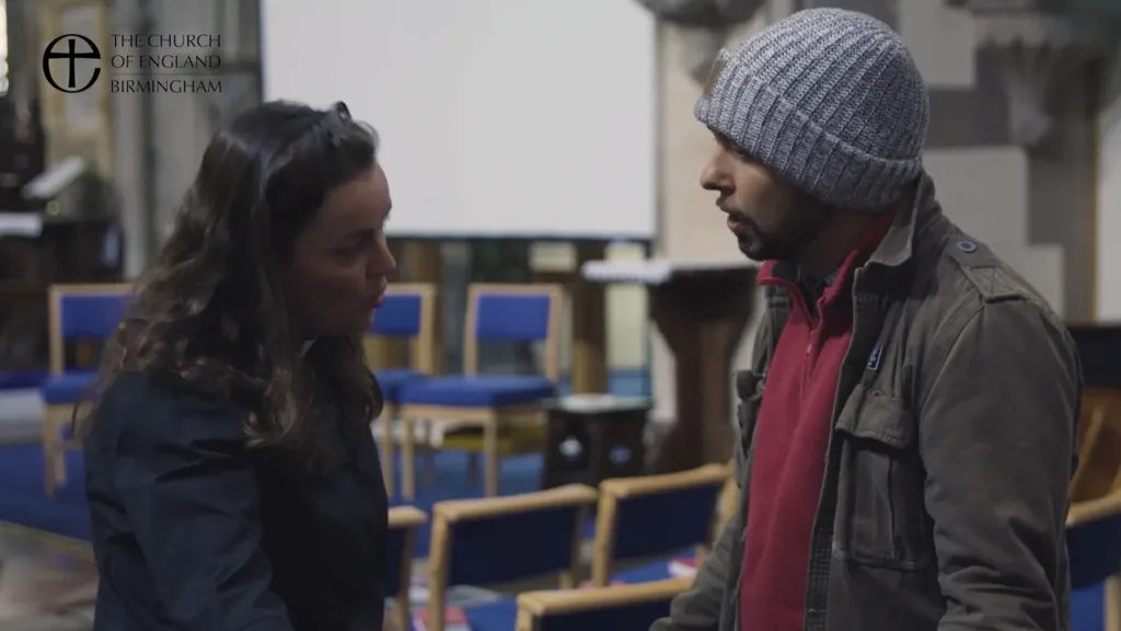 Actor-led church safeguarding training scene produced for Church of England Birmingham, showing a discussion between two people inside a church setting.