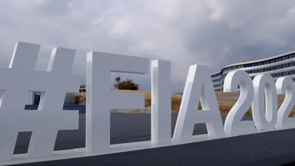 Large white hashtag FIA2022 sign displayed outdoors near a modern building