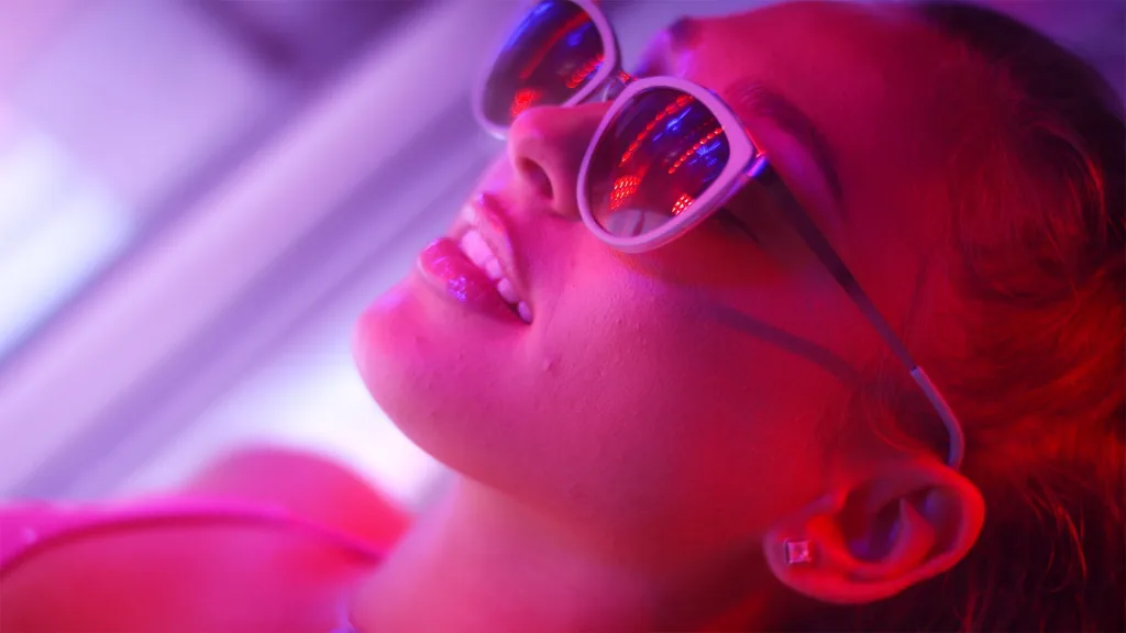 Beautiful young woman lying on a sunbed studio shot