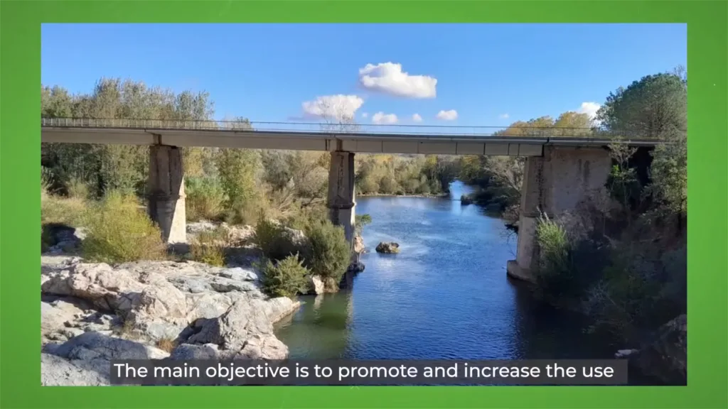 A wide shot of a concrete bridge spanning a clear river in a wooded landscape, featured in a Climate-KIC environmental film by Floating Harbour exploring sustainable transport and climate innovation.
