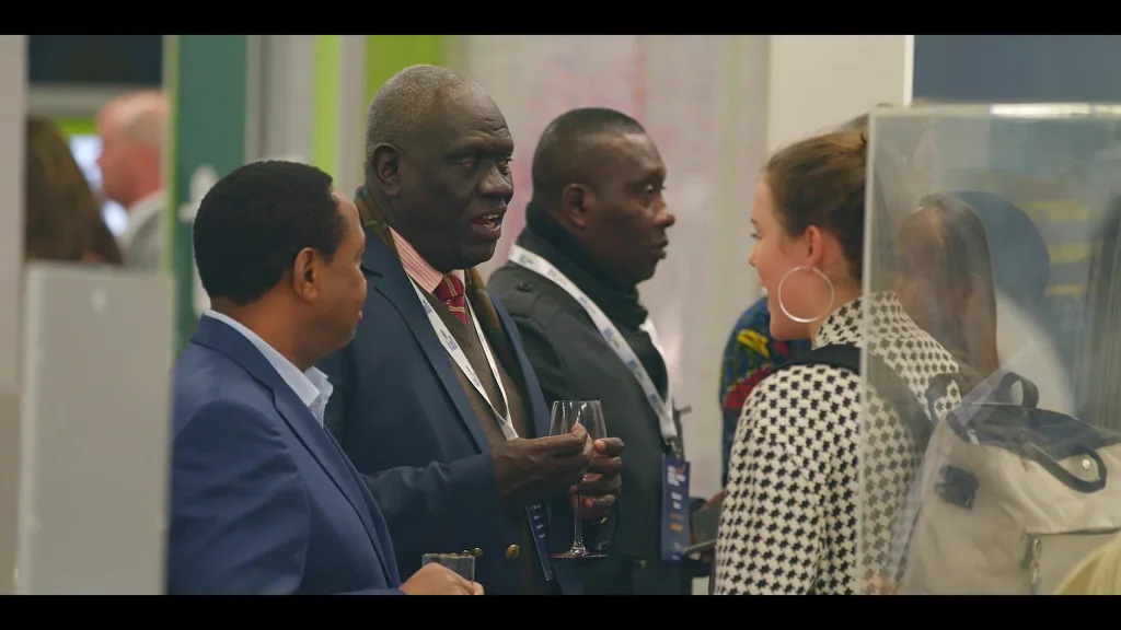 Delegates mingle at Data for Development Festival with a large audience and conference branding