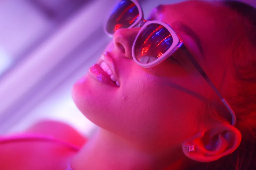 Beautiful young woman lying on a sunbed studio shot