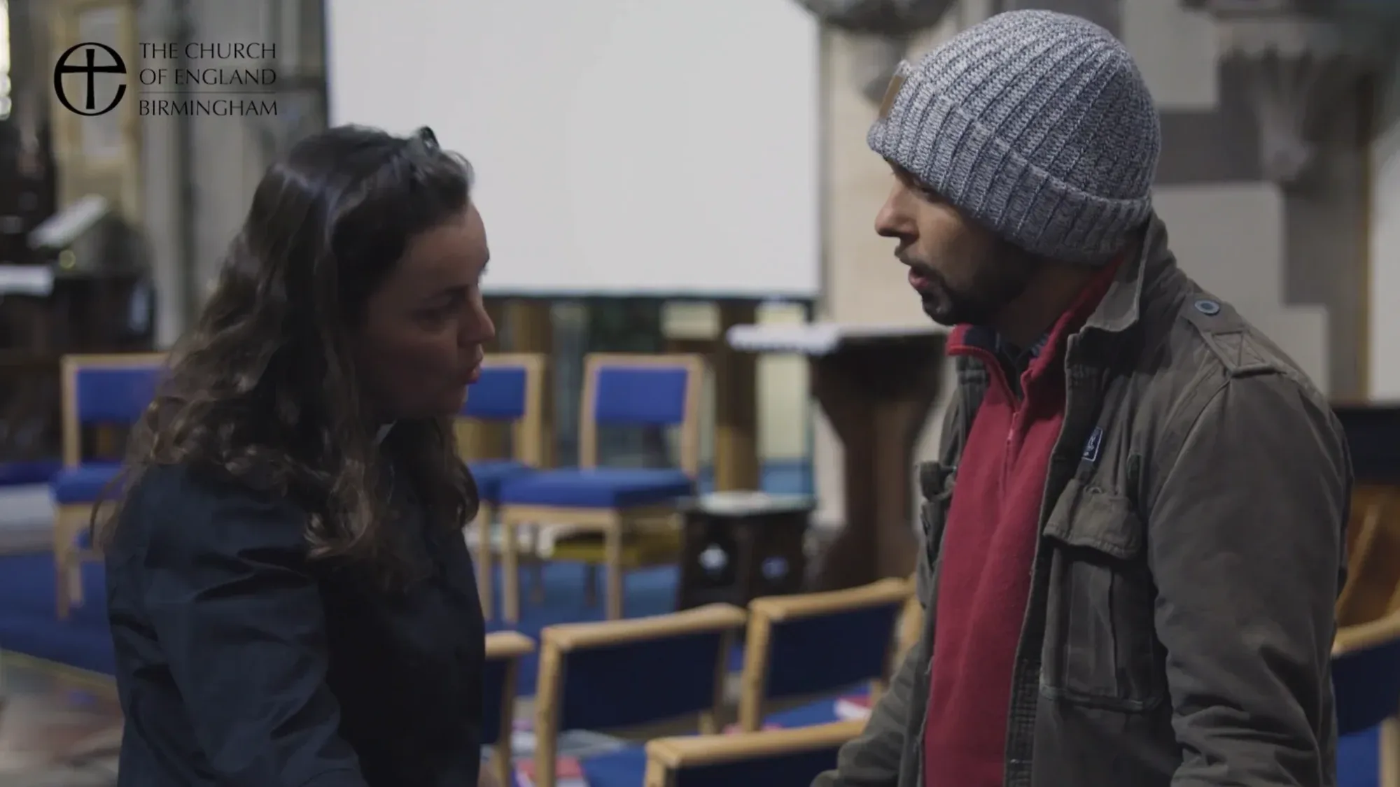 Actor-led church safeguarding training scene produced for Church of England Birmingham, showing a discussion between two people inside a church setting.
