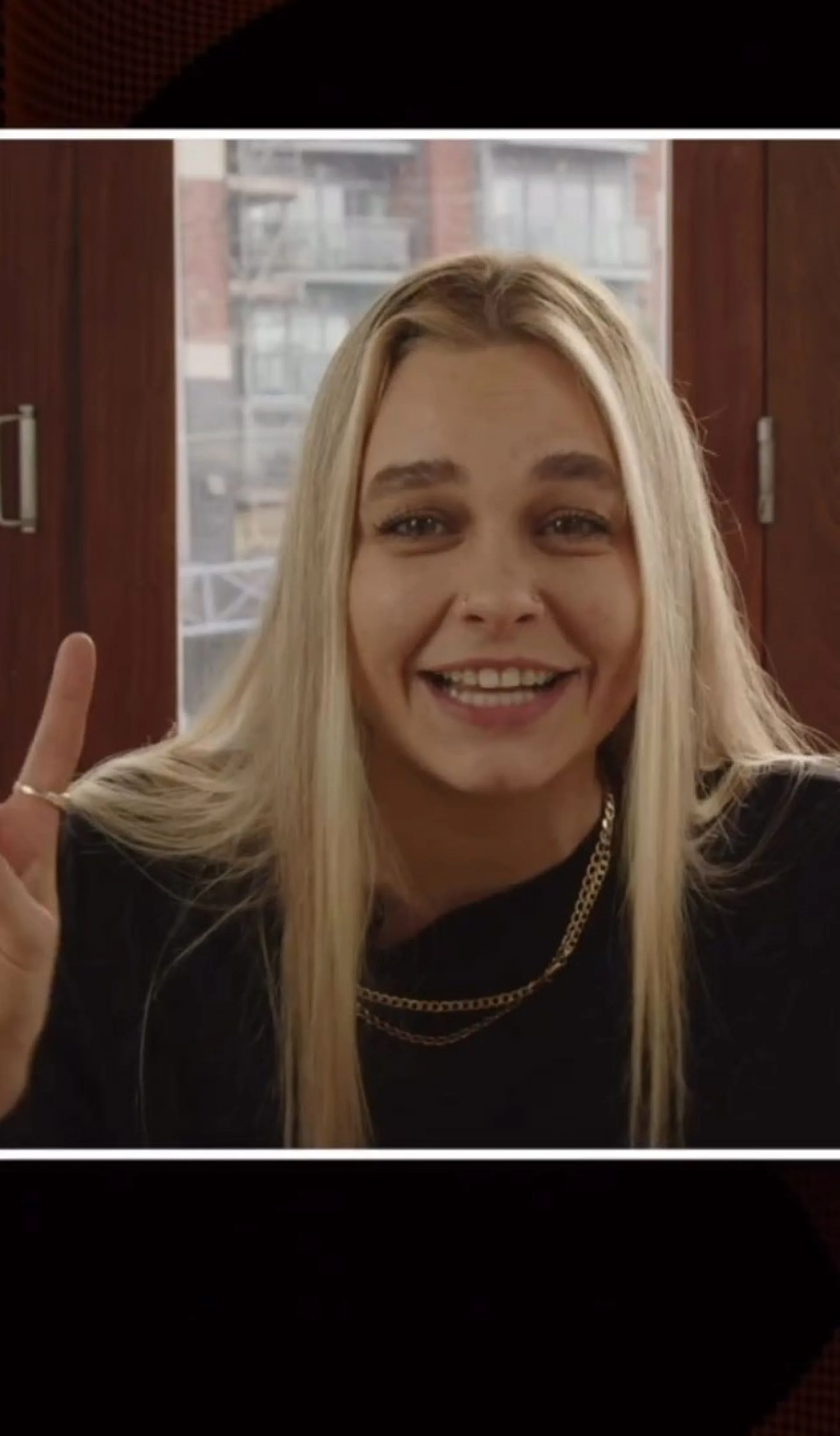 A portrait of musician Kimmy Beatbox smiling and giving a peace sign, filmed during a social content production shoot for Creative UK and the Creative Coalition Festival.