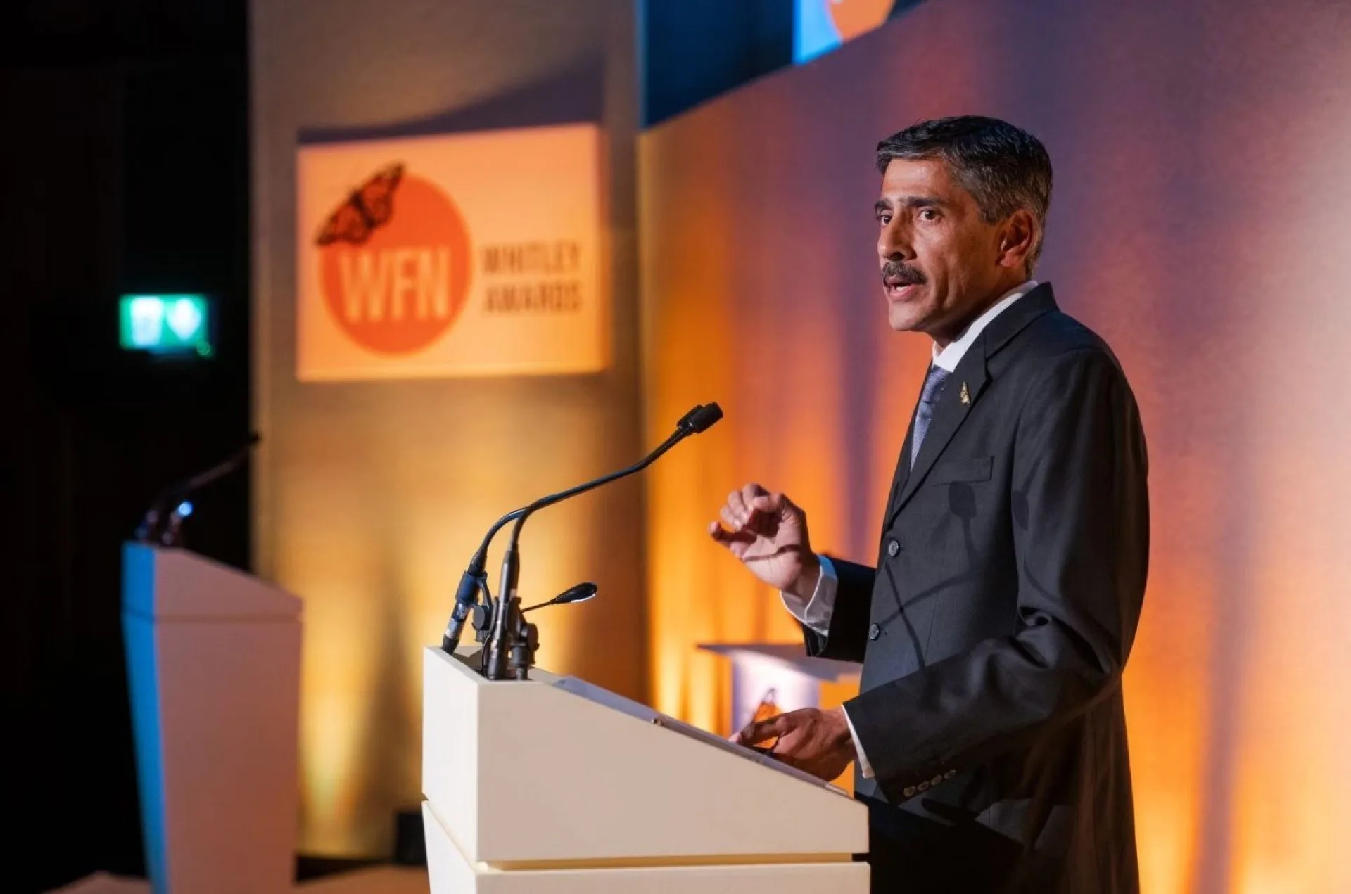 A speaker at the podium at the Whitley Awards event filmed at the RGS in London. Floating Harbour also live streamed the event.